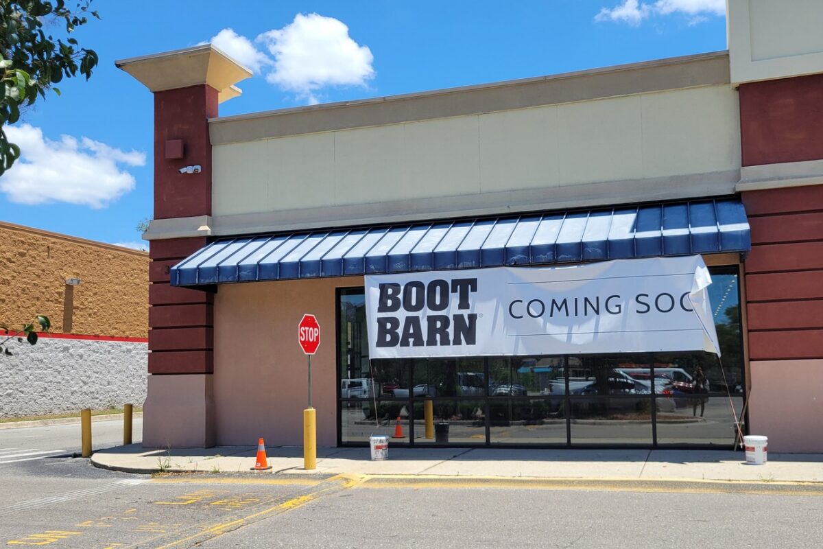 A storefront with a sign that reads "Boot Barn Coming Soon."