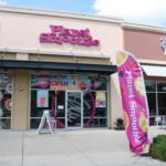 Exterior view of a shopping plaza. Three restaurants stand next to eachother, Crumbl, Planet Smoothie and The Great Mediterranean.