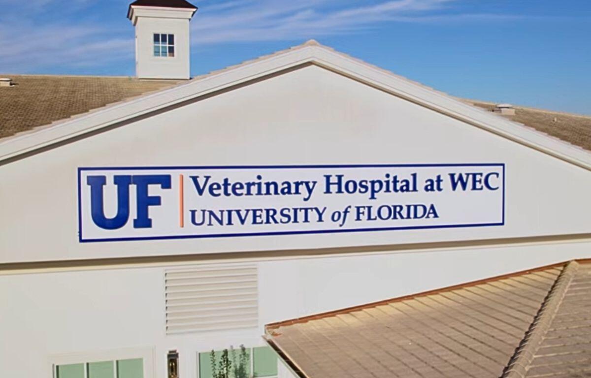 A white building that reads, "UF Veterinary Hospital at WEC, University of Florida."