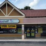 A storefront with closing signage.