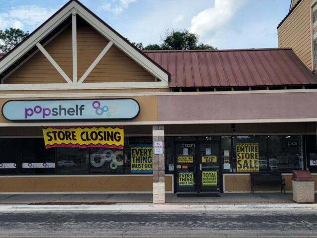 A storefront with closing signage.