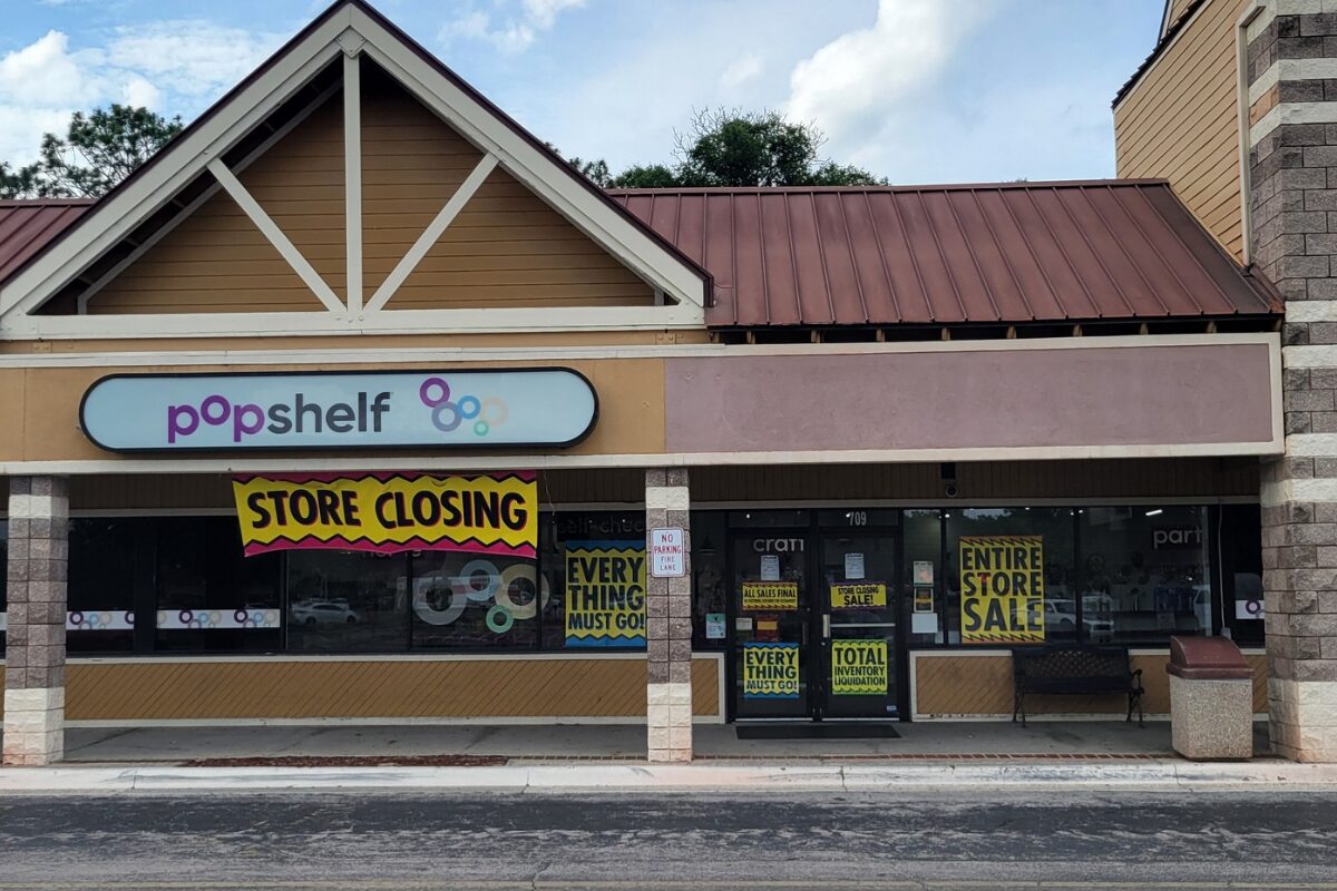 A storefront with closing signage.