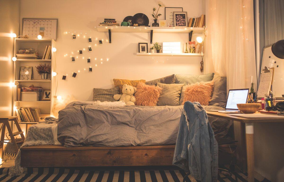 A dimly lit, cozy dorm room with decorations.
