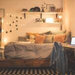 A dimly lit, cozy dorm room with decorations.