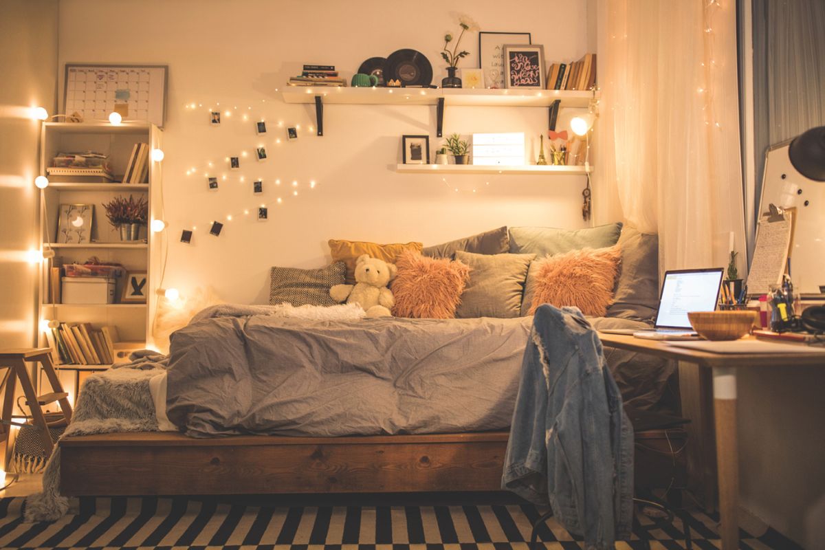 A dimly lit, cozy dorm room with decorations.