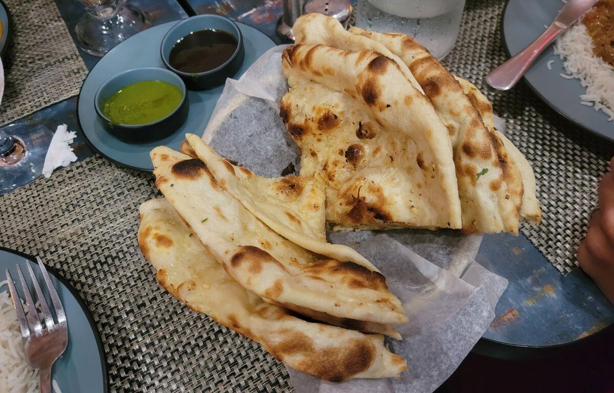 A plate of garlic naan bread on a table.