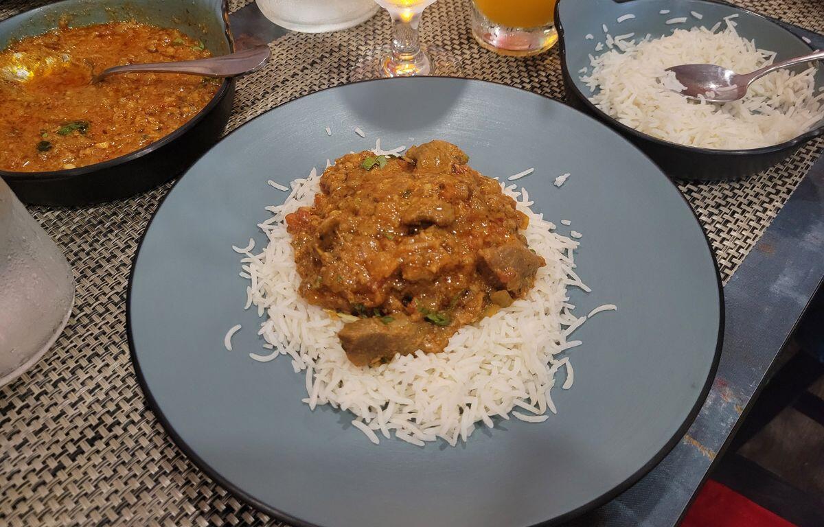 Chicken tikki masala on a table with basmati rice.