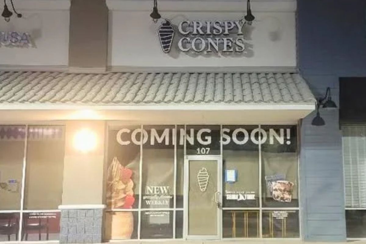 A dark storefront with a large sign reading, "Crispy Cones."