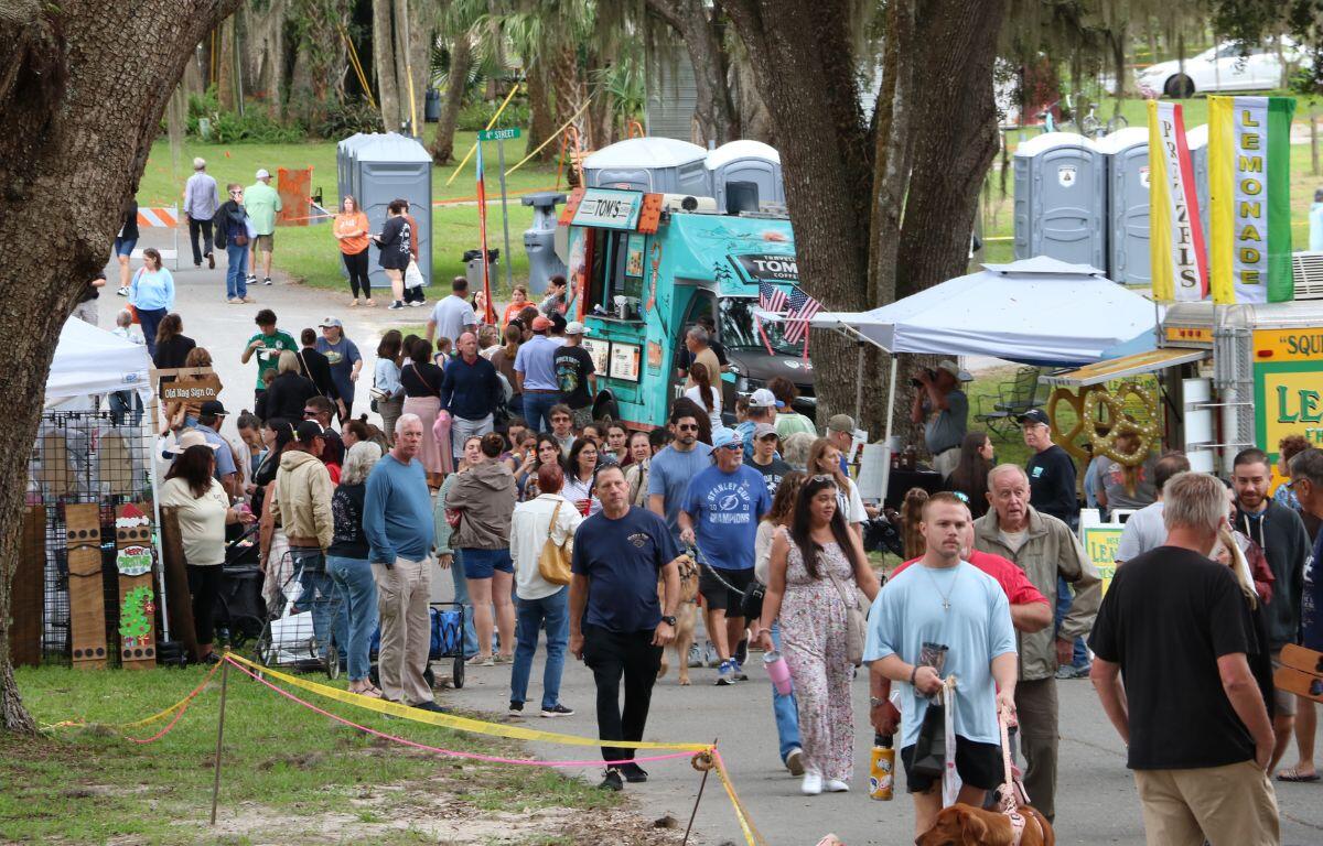 Crowd walks through town festival.