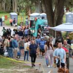 Crowd walks through town festival.
