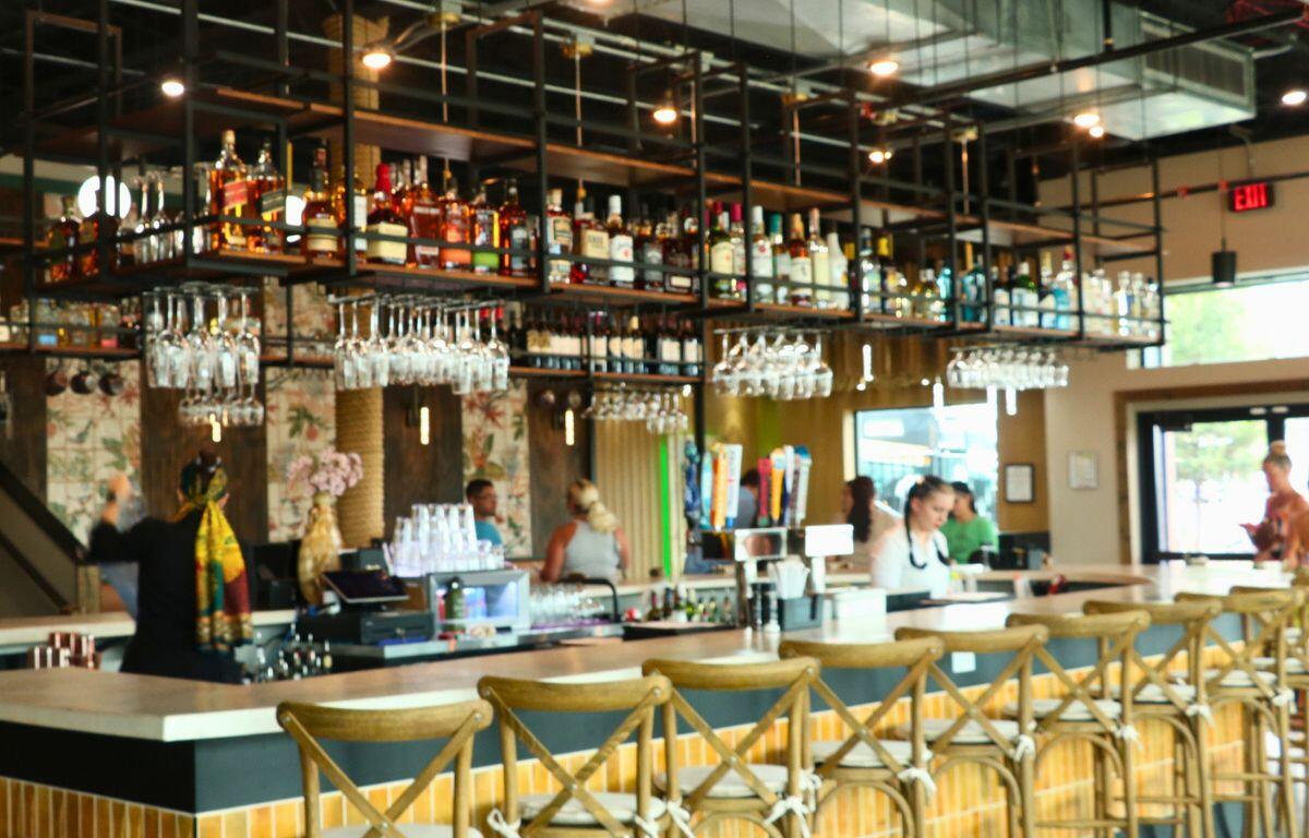 A brightly lit bar in the center of a restaurant.